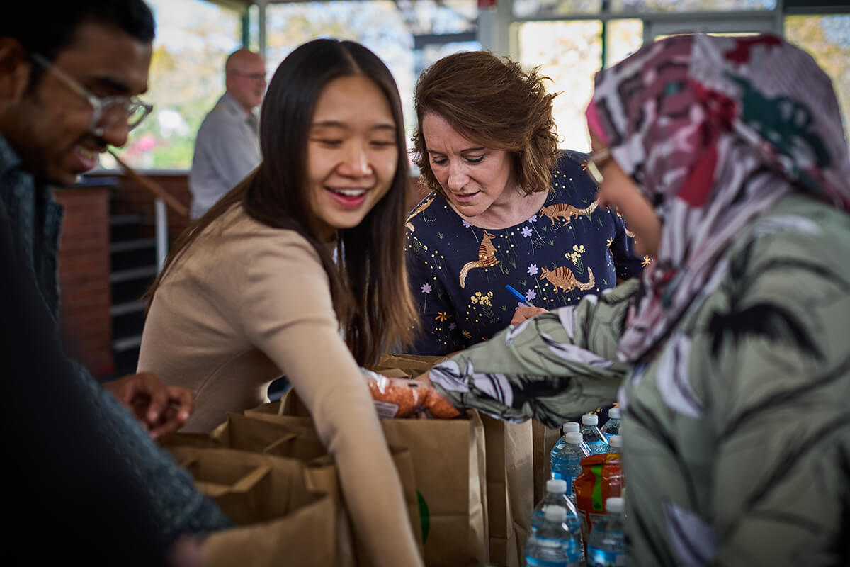 Volunteer sorts food donation on the table.